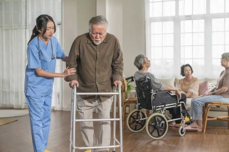 young asian female nurse care giver helping asian senior old man with mobility walker living area nursing home senior daycare centernurse take care elderly patient with cheerful concentrate